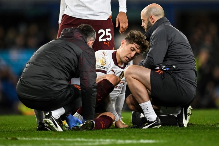 Manchester Citys English defender #05 John Stones receives medical treatment during the English Premier League football match between Everton and Manchester City at Goodison Park in Liverpool, north west England on December 27, 2023. (Photo by Paul ELLIS / AFP) / RESTRICTED TO EDITORIAL USE. No use with unauthorized audio, video, data, fixture lists, club/league logos or live services. Online in-match use limited to 120 images. An additional 40 images may be used in extra time. No video emulation. Social media in-match use limited to 120 images. An additional 40 images may be used in extra time. No use in betting publications, games or single club/league/player publications. /