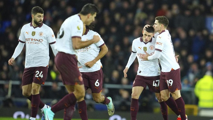 Manchester Citys Phil Foden, second right, is congratulated after scoring his sides first goal during the English Premier League soccer match between Everton and Manchester City at Goodison Park stadium in Liverpool, England, Wednesday, Dec. 27, 2023. (AP Photo/Jon Super)