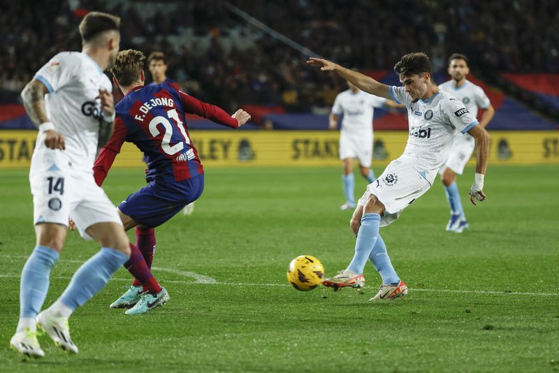 Girona's Miguel Gutierrez scores his side's second goal during the Spanish La Liga soccer match between Barcelona and Girona at the Olimpic Lluis Companys stadium in Barcelona, Spain, Sunday, Dec. 10, 2023. (AP Photo/Joan Monfort)