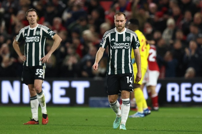 Manchester United Northern Irish defender #35 Jonny Evans (L) and Manchester Uniteds Danish midfielder #14 Christian Eriksen (R) react after conceding the first goal during the English Premier League football match between Nottingham Forest and Manchester United at The City Ground in Nottingham, central England, on December 30, 2023. (Photo by Darren Staples / AFP) / RESTRICTED TO EDITORIAL USE. No use with unauthorized audio, video, data, fixture lists, club/league logos or live services. Online in-match use limited to 120 images. An additional 40 images may be used in extra time. No video emulation. Social media in-match use limited to 120 images. An additional 40 images may be used in extra time. No use in betting publications, games or single club/league/player publications. /