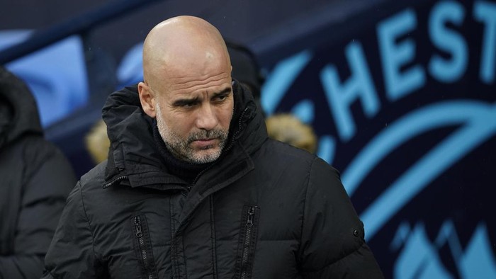 Manchester Citys head coach Pep Guardiola looks from the bench before the English Premier League soccer match between Manchester City and Sheffield United at the Etihad stadium in Manchester, England, Saturday, Dec. 30, 2023. (AP Photo/Dave Thompson)