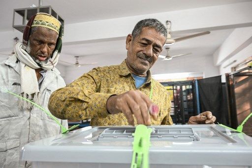 A man votes in Bangladesh's general election in Dhaka on January 7, 2024. (Photo by INDRANIL MUKHERJEE / AFP)