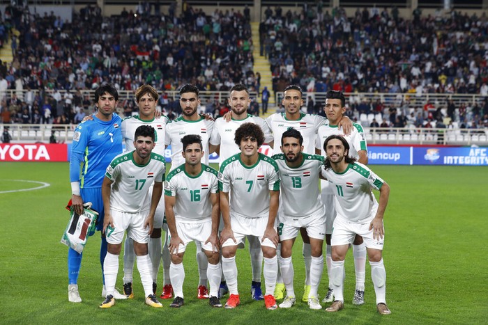 Iraqs soccer team players pose for a team photo at the start of the AFC Asian Cup round of 16 soccer match between Qatar and Iraq at Al Nahyan Stadium in Abu Dhabi, United Arab Emirates, Tuesday, Jan. 22, 2019. (AP Photo/Hassan Ammar)