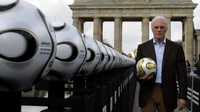FILE PHOTO: Franz Beckenbauer, President of Germany's World Cup organising committee, holds a golden soccer ball during a presentation next to the Brandenburg gate in Berlin, Germany April 18, 2006. REUTERS/Tobias Schwarz/File Photo