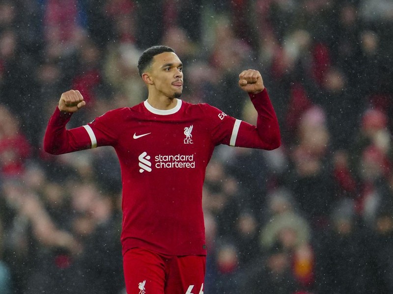 Liverpool's Trent Alexander-Arnold celebrates at the end of the English Premier League soccer match between Liverpool and Newcastle, at Anfield stadium in Liverpool, England, Monday, Jan. 1, 2024. (AP Photo/Jon Super)