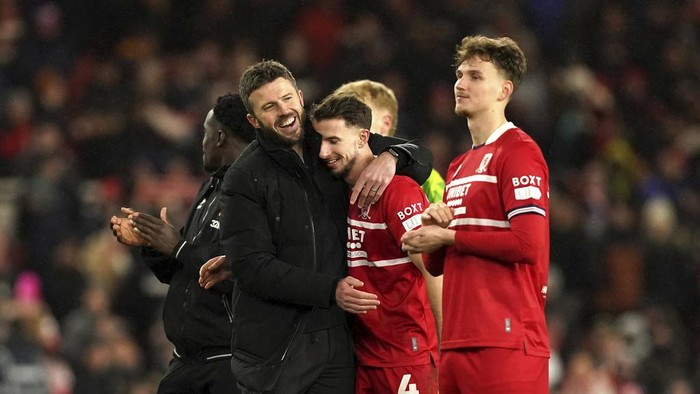 Middlesbrough manager Michael Carrick, left, celebrates with player Dan Barlaser after the final whistle in the English League Cup semi final first leg soccer match between Middlesbrough and Chelsea, at the Riverside Stadium, in Middlesbrough, England, Tuesday, Jan. 9, 2024. (Martin Rickett/PA via AP)