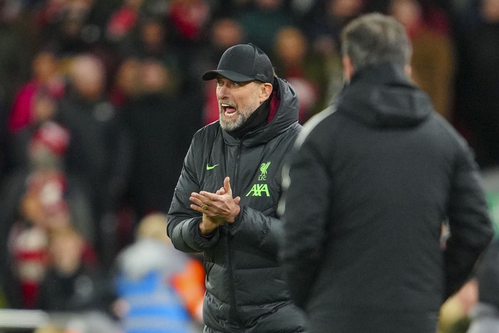 Liverpools manager Jurgen Klopp, left, reacts during the EFL Cup first leg semi final soccer match between Liverpool and Fulham at Anfield stadium in Liverpool, England, Wednesday, Jan. 10, 2024. (AP Photo/Jon Super)