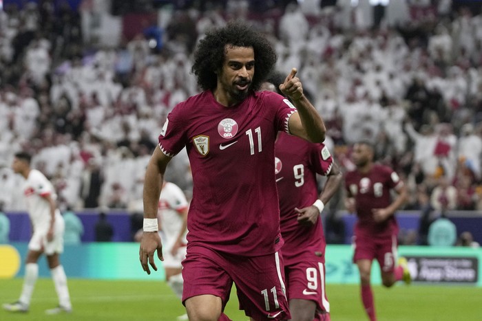 Qatars Akram Afif celebrates after scoring the opening goal during the Asian Cup Group A soccer match between Qatar and Lebanon at the Lusail Stadium in Lusail, Qatar, Friday, Jan. 12, 2024. (AP Photo/Thanassis Stavrakis)