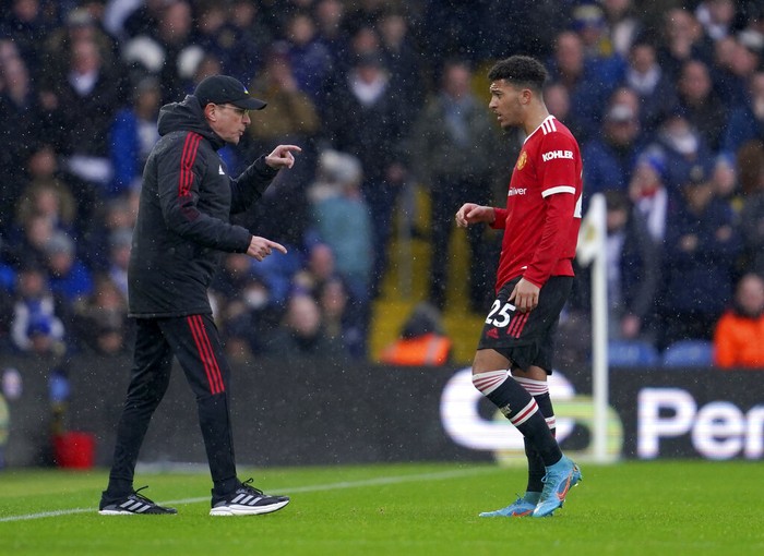Manchester Uniteds interim manager Ralf Rangnick, left, gives instructions to Manchester Uniteds Jadon Sancho during the English Premier League soccer match between Leeds United and Manchester United, at Elland Road Stadium in Leeds, England, Sunday, Feb. 20, 2022. (AP Photo/Jon Super)