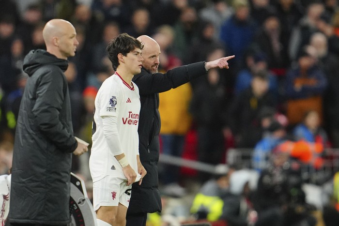 Manchester Uniteds head coach Erik ten Hag, right, talks to Manchester Uniteds Facundo Pellistri during a substitution at the English Premier League soccer match between Liverpool and Manchester United at the Anfield stadium in Liverpool, England, Sunday, Dec.17, 2023. (AP Photo/Jon Super)