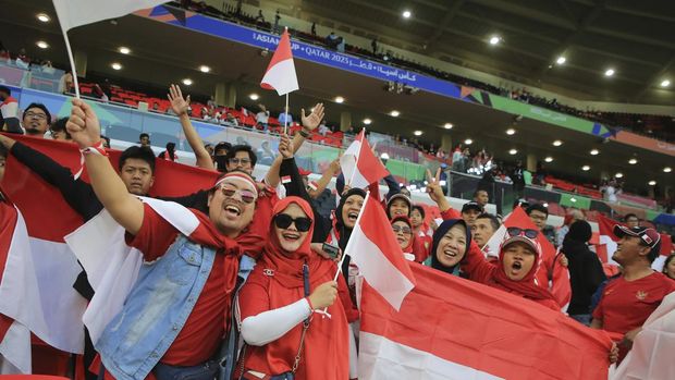 Indonesian fans wave flags ahead of the Asian Cup Group D soccer match between Indonesia and Iraq at Ahmad Bin Ali Stadium in Al Rayyan, Qatar, Monday, Jan. 15, 2024. (AP Photo/Hussein Sayed)