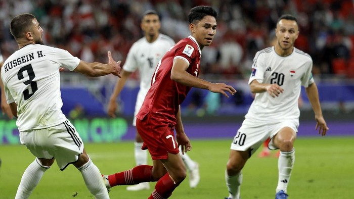 Indonesias midfielder #07 Marselino Ferdinan fights for the ball with Iraqs defender #03 Hussein Ali and midfielder #20 Osama Rashid during the Qatar 2023 AFC Asian Cup Group D football match between Indonesia and Iraq at the Ahmad bin Ali Stadium in Al-Rayyan, west of Doha on January 15, 2024. (Photo by KARIM JAAFAR / AFP)