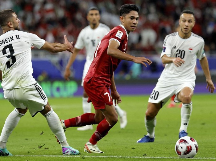 Indonesias midfielder #07 Marselino Ferdinan fights for the ball with Iraqs defender #03 Hussein Ali and midfielder #20 Osama Rashid during the Qatar 2023 AFC Asian Cup Group D football match between Indonesia and Iraq at the Ahmad bin Ali Stadium in Al-Rayyan, west of Doha on January 15, 2024. (Photo by KARIM JAAFAR / AFP)