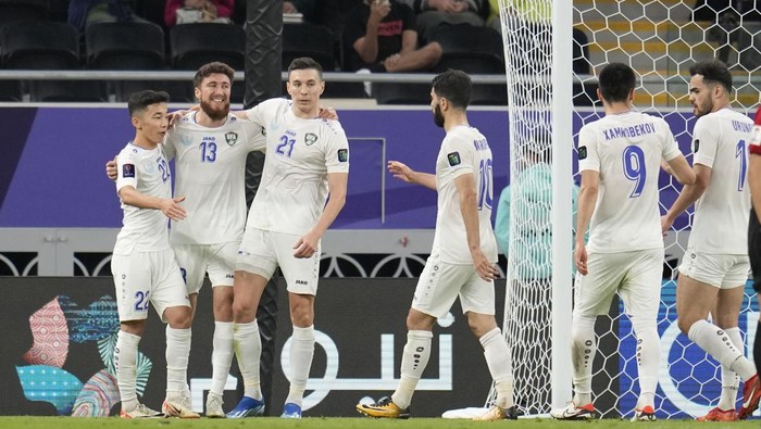 Uzbekistans Sherzod Nasrullaev, second left, celebrates with teammates after scoring his sides third goal during the Asian Cup Group B soccer match between India and Uzbekistan at Ahmad Bin Ali Stadium stadium, in Doha, Qatar, Thursday, Jan. 18, 2024. (AP Photo/Aijaz Rahi)