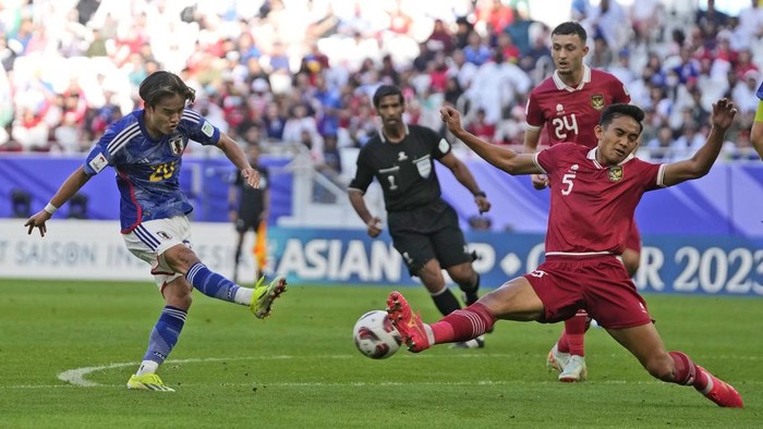 Indonesias Rizky Ridh Ramadhani blocks Japans Takefusa Kubo shoot during the Asian Cup Group D soccer match between Japan and Indonesia at Al Thumama in Doha, Qatar, Wednesday, Jan. 24, 2024. (AP Photo/Thanassis Stavrakis)