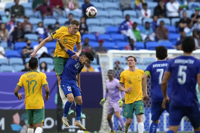 Australias Harry Souttar heads the ball over Uzbekistans Abbosbek Fayzullaev during the Asian Cup Group B soccer match between Australia and Uzbekistan at Al Janoub Stadium in Doha, Qatar, Tuesday, Jan. 23, 2024. (AP Photo/Thanassis Stavrakis)