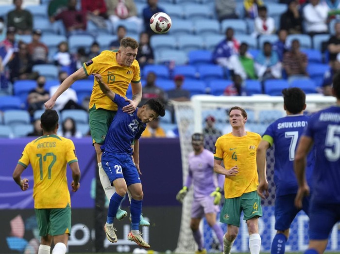 Australia's Harry Souttar heads the ball over Uzbekistan's Abbosbek Fayzullaev during the Asian Cup Group B soccer match between Australia and Uzbekistan at Al Janoub Stadium in Doha, Qatar, Tuesday, Jan. 23, 2024. (AP Photo/Thanassis Stavrakis)