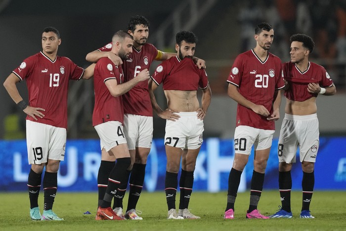 Egypt players watch the penalty shootout during the African Cup of Nations Round of 16 soccer match between Egypt and DR Congo, at the Laurent Pokou stadium in San Pedro, Ivory Coast, Sunday, Jan. 28, 2024. 2024. DR Congo won 8-7 after penalties. (AP Photo/Sunday Alamba)