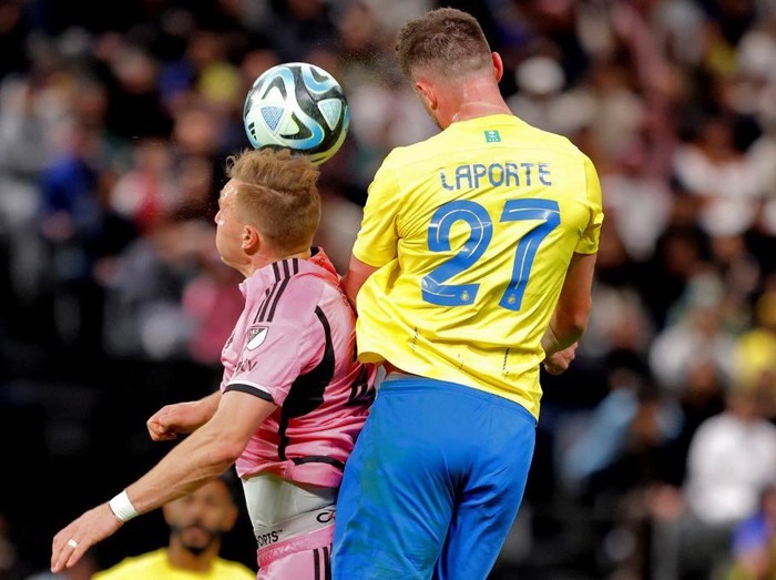 Inter Miami's Ukrainian defender #27 Sergii Kryvtsov and Nassr's French defender #27 Aymeric Laporte vie for a header during the friendly football match between Saudi Arabia's al-Nassr FC and the US Inter Miami CF at the Kingdom Arena Stadium in Riyadh on February 1, 2024. (Photo by AFP)