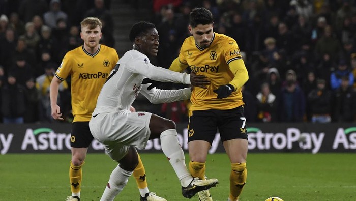 Wolverhampton Wanderers Pedro Neto, right, is challenged by Manchester Uniteds Kobbie Mainoo during the English Premier League soccer match between Wolverhampton Wanderers and Manchester United at the Molineux Stadium in Wolverhampton, England, Thursday, Feb. 1, 2024. (AP Photo/Rui Vieira)
