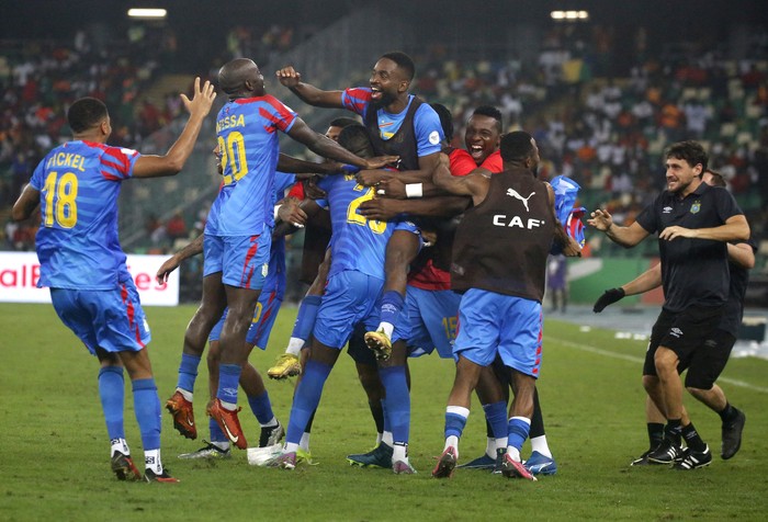 Soccer Football - Quarter Final - DR Congo v Guinea - Alassane Ouattara Olympic Stadium, Abidjan, Ivory Coast - February 2, 2024 DR Congos Arthur Masuaku celebrates scoring their third goal with teammates REUTERS/Luc Gnago