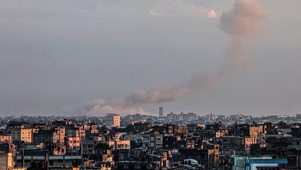 A picture taken from Rafah in the southern Gaza Strip shows smoke rising over buildings in Khan Yunis during Israeli bombardment on February 2, 2024, as fighting continues between Israel and the Palestinian Hamas group. (Photo by Said KHATIB / AFP)