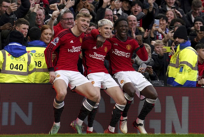 Manchester Uniteds Alejandro Garnacho, centre, celebrates with Rasmus Hojlund, left, and Kobbie Mainoo after scoring their sides second goal of the game during the Premier League match between Manchester United and West Ham United at Old Trafford, Manchester, England, Sunday Feb. 4, 2024. (Martin Rickett/PA via AP)