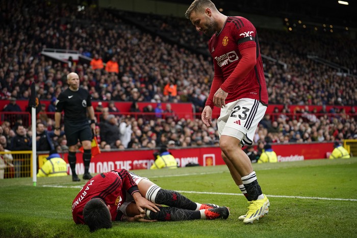 Manchester Uniteds Lisandro Martinez lies on the pitch after an injury during the English Premier League soccer match between Manchester United and West Ham United at the Old Trafford stadium in Manchester, England, Sunday, Feb. 4, 2024. (AP Photo/Dave Thompson)