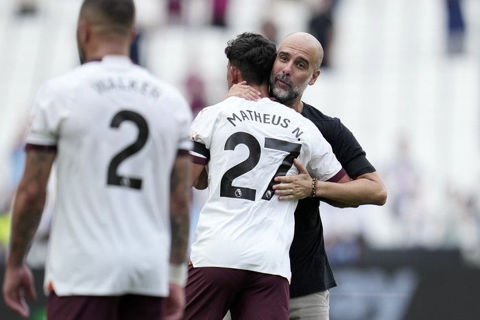 Manchester Citys head coach Pep Guardiola celebrates with Manchester Citys Matheus Nunes at the end of the English Premier League soccer match between West Ham United and Manchester City at London stadium in London, Saturday, Sept. 16, 2023. Manchester City won 3-1. (AP Photo/Kin Cheung)