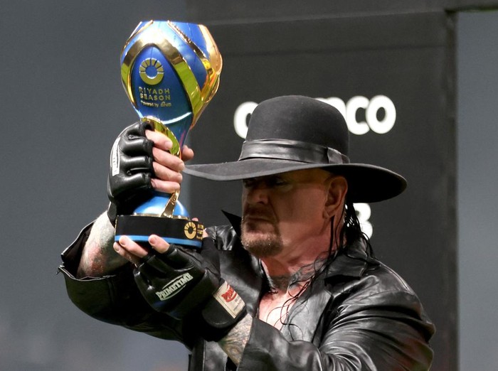 Soccer Football - Friendly - Al Nassr v Al Hilal - Kingdom Arena, Riyadh, Saudi Arabia - February 8, 2024 Wrestler The Undertaker holds a trophy before the match REUTERS/Ahmed Yosri