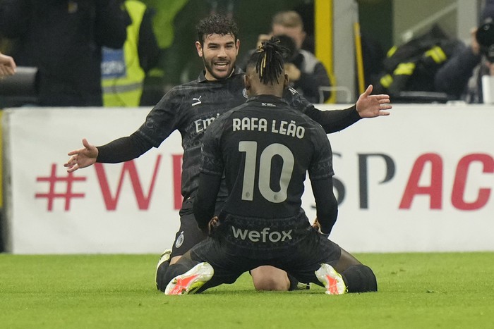 AC Milans Theo Hernandez, right, celebrates with AC Milans Rafael Leao after scoring his sides first goal during a Serie A soccer match between AC Milan and Napoli, at the San Siro stadium in Milan, Italy, Sunday, Feb. 11, 2024. (AP Photo/Luca Bruno)