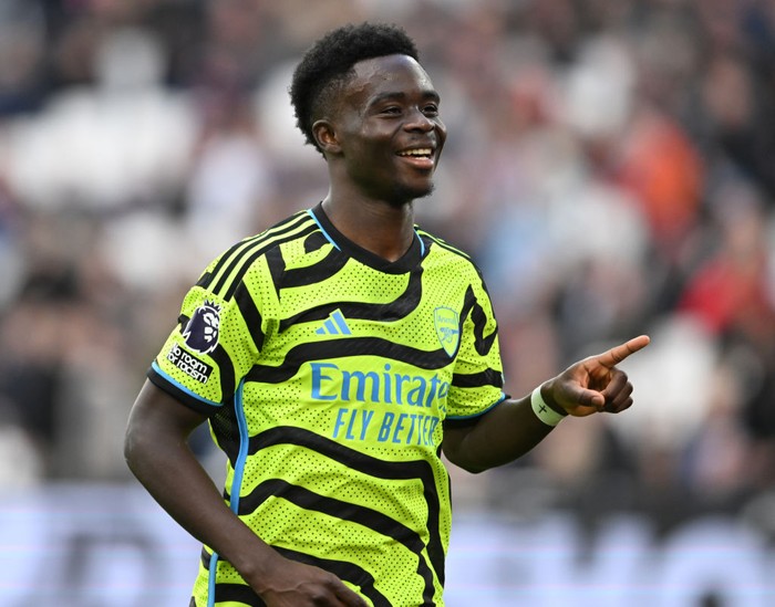 Bukayo Saka LONDON, ENGLAND - FEBRUARY 11: Bukayo Saka celebrates scoring the 5th Arsenal goal during the Premier League match between West Ham United and Arsenal FC at London Stadium on February 11, 2024 in London, England. (Photo by Stuart MacFarlane/Arsenal FC via Getty Images)