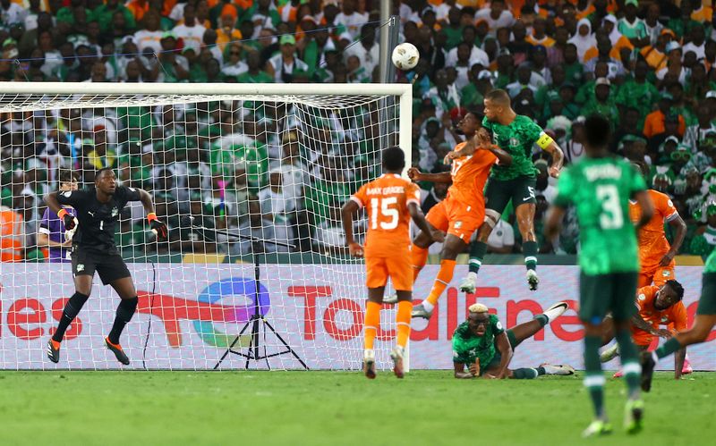 Soccer Football - Africa Cup of Nations - Final - Nigeria v Ivory Coast - Stade Olympique Alassane Ouattara, Abidjan, Ivory Coast - February 11, 2024 Nigeria's William Troost-Ekong scores their first goal REUTERS/Siphiwe Sibeko