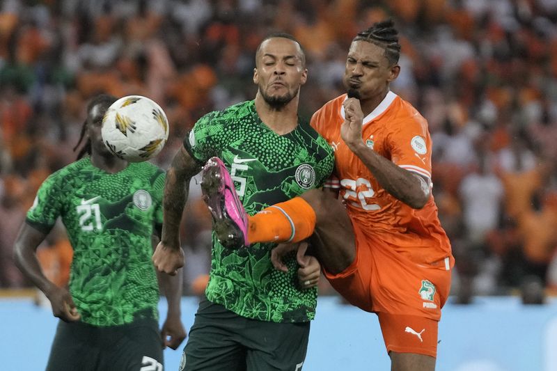 Ivory Coast 's Sebastien Haller, right, scores his side's second goal during the African Cup of Nations final soccer match between Ivory Nigeria and Coast, at the Olympic Stadium of Ebimpe in Abidjan, Ivory Coast, Sunday, Feb. 11, 2024. (AP Photo/Themba Hadebe)