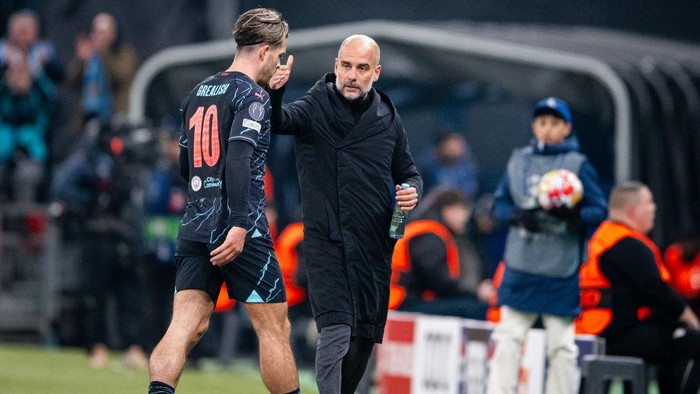 COPENHAGEN, DENMARK - FEBRUARY 13: Jack Grealish of Manchester City and Josep Guardiola of Manchester City gestures during the UEFA Champions League 2023/24 round of 16 first leg match between F.C. Copenhagen and Manchester City at Parken Stadium on February 13, 2024 in Copenhagen, Denmark. (Photo by Mateusz Slodkowski/Getty Images)