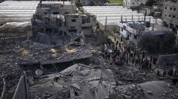Palestinians inspect the damage to residential buildings where two Israeli hostages were reportedly held before being rescued during an operation by Israeli security forces in Rafah, southern Gaza Strip, Monday, Feb. 12, 2024. The Israeli military said early Monday that it had rescued the two hostages from captivity in the Gaza Strip. The operation, which was accompanied by airstrikes, killed dozens of Palestinians, according to local health officials. (AP Photo/Fatima Shbair)
