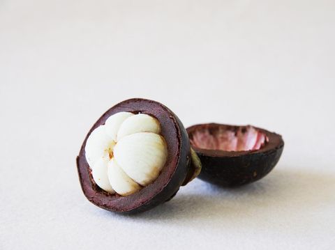 Mangosteen Thai popular fruits - a tropical fruit with sweet juicy white segments of flesh inside a thick reddish-brown rind.