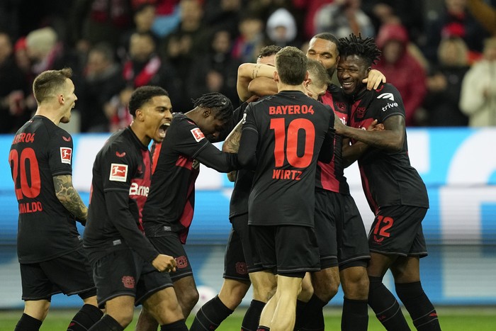 Leverkusen's team players celebrate after Robert Andrich scored his side's second goal during the German Bundesliga soccer match between Bayer 04 Leverkusen and 1. FSV Mainz 05 at the BayArena in Leverkusen, Germany, Friday, Feb. 23, 2024. (AP Photo/Martin Meissner)