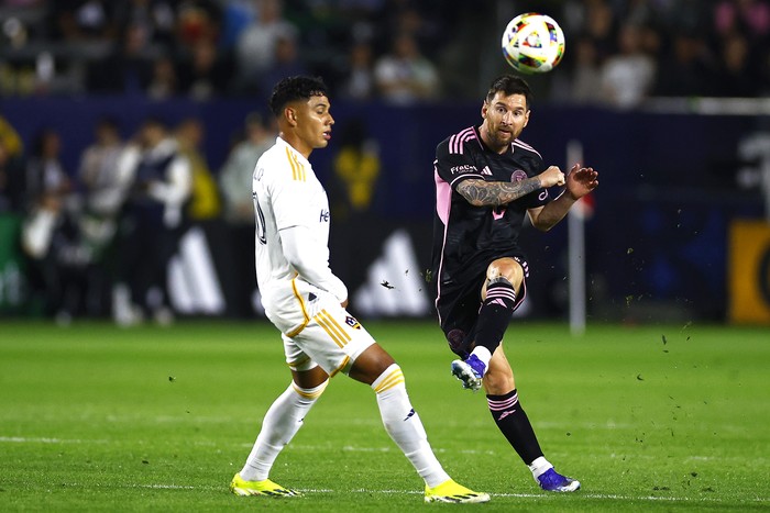 CARSON, CALIFORNIA - FEBRUARY 25: Lionel Messi #10 of Inter Miami CF kicks the ball against Edwin Cerrillo #20 of Los Angeles Galaxy in the first half at Dignity Health Sports Park on February 25, 2024 in Carson, California. (Photo by Ronald Martinez/Getty Images)