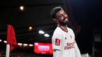 Bruno Fernandes tertawa karena Felipe lolos dari kartu. Foto: AFP/OLI SCARFF