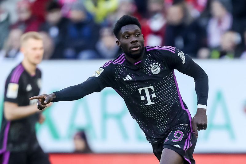  Alphonso Davies of Bayern Muenchen gestures during the Bundesliga match between FC Augsburg and FC Bayern München at WWK-Arena on January 27, 2024 in Augsburg, Germany. (Photo by DeFodi Images via Getty Images)