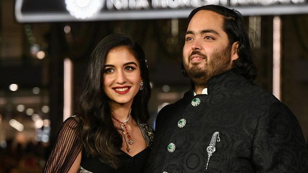 In this picture taken on March 31, 2023, Anant Ambani (R), son of Indian businessman Mukesh Dhirubhai Amani, and his wife Radhika Merchant pose for pictures during the inauguration of the Nita Mukesh Ambani Cultural Centre (NMACC) at the Jio World Centre (JWC) in Mumbai. (Photo by SUJIT JAISWAL / AFP)