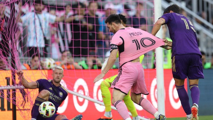 Mar 2, 2024; Fort Lauderdale, Florida, USA; Inter Miami CF forward Lionel Messi (10) scores a goal as his jersey is pulled by Orlando City defender Rodrigo Schlegel (15) in the second half at Chase Stadium. Mandatory Credit: Nathan Ray Seebeck-USA TODAY Sports