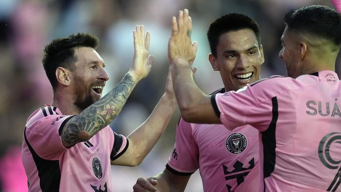 Inter Miami forward Lionel Messi, left, celebrates with Inter Miami midfielder Diego Gomez, center, and Inter Miami forward Luis Suarez (9) after scoring his sides fifth goal during the second half of an MLS soccer match against Orlando City, Saturday, March 2, 2024, in Fort Lauderdale, Fla. (AP Photo/Rebecca Blackwell)