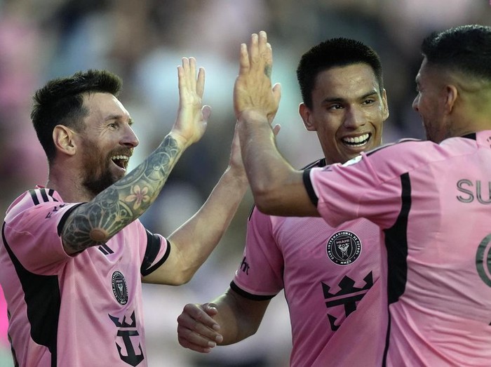 Inter Miami forward Lionel Messi, left, celebrates with Inter Miami midfielder Diego Gomez, center, and Inter Miami forward Luis Suarez (9) after scoring his side's fifth goal during the second half of an MLS soccer match against Orlando City, Saturday, March 2, 2024, in Fort Lauderdale, Fla. (AP Photo/Rebecca Blackwell)