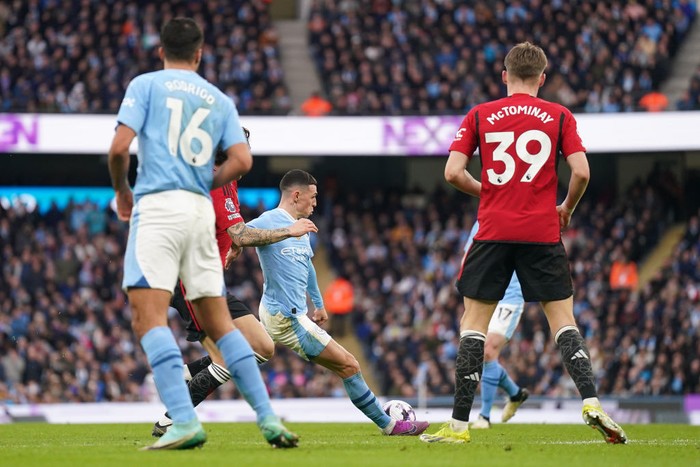 Manchester Citys Phil Foden (centre) scores their sides first goal of the game during the Premier League match at the Etihad Stadium, Manchester. Picture date: Sunday March 3, 2024. (Photo by Mike Egerton/PA Images via Getty Images)