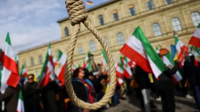 A noose is seen as people hold Iranian flags during a protest in Munich, Germany, Feb. 17, 2023. (Reuters)
