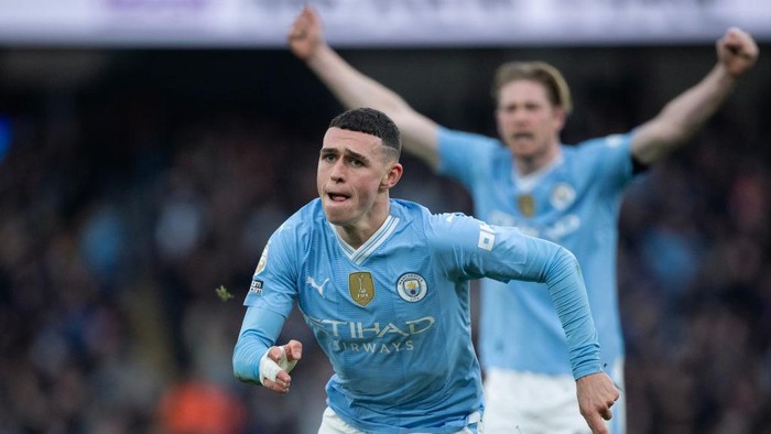 MANCHESTER, ENGLAND - MARCH 3: Phil Foden of Manchester City celebrates scoring his teams first goal during the Premier League match between Manchester City and Manchester United at Etihad Stadium on March 3, 2024 in Manchester, England. (Photo by Joe Prior/Visionhaus via Getty Images)