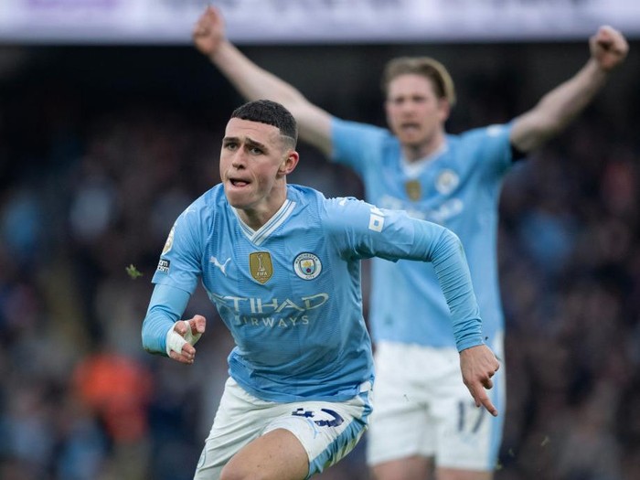 MANCHESTER, ENGLAND - MARCH 3: Phil Foden of Manchester City celebrates scoring his team's first goal during the Premier League match between Manchester City and Manchester United at Etihad Stadium on March 3, 2024 in Manchester, England. (Photo by Joe Prior/Visionhaus via Getty Images)