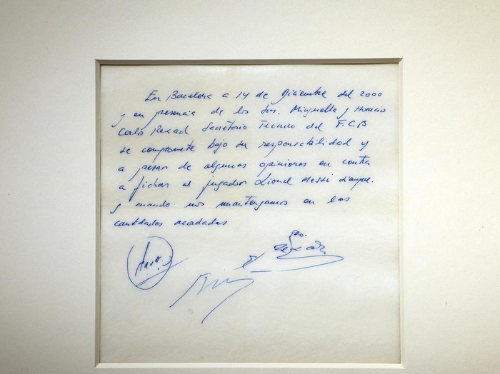 A guest looks at a napkin, written on by Barcelona's Sporting Director at that time Carles Rexach on December 14, 2000, promising a contract to secure 13-year-old Lionel Messi for FC Barcelona, on display at Bonhams Auctions in New York City, U.S., March 6, 2024.  REUTERS/Brendan McDermid